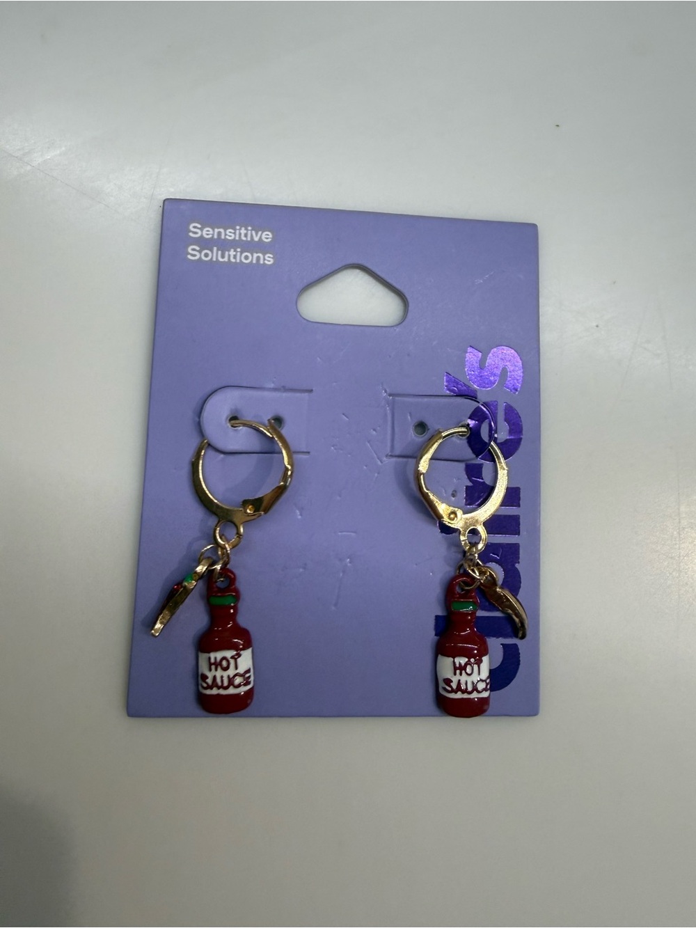 Claire's Gold Hoop Earrings with Red Hot Sauce Bottle Charms